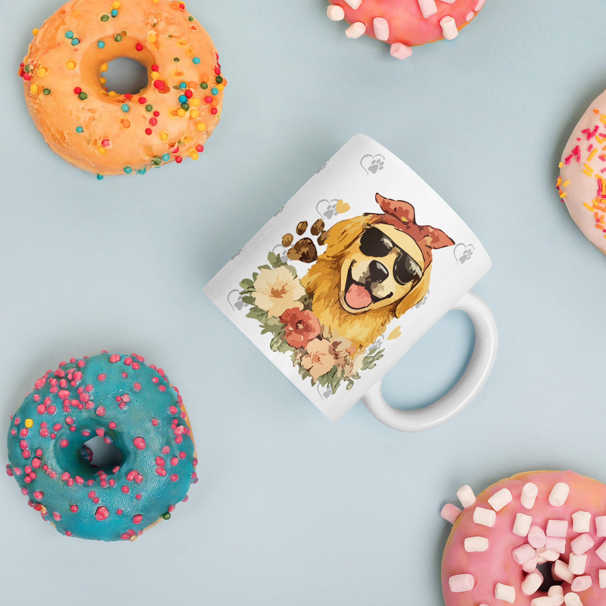 white-glossy-mug-white-11-oz-donuts-6a1b32ad4a4d9jpg - Golden Retriever Gift Shop Optional tagline if the builder asks for one: Life is Better with Goldens Flat lay of colorful donuts with icing and sprinkles on a pale blue background, alongside a dog-illustration mug and a decorative card.