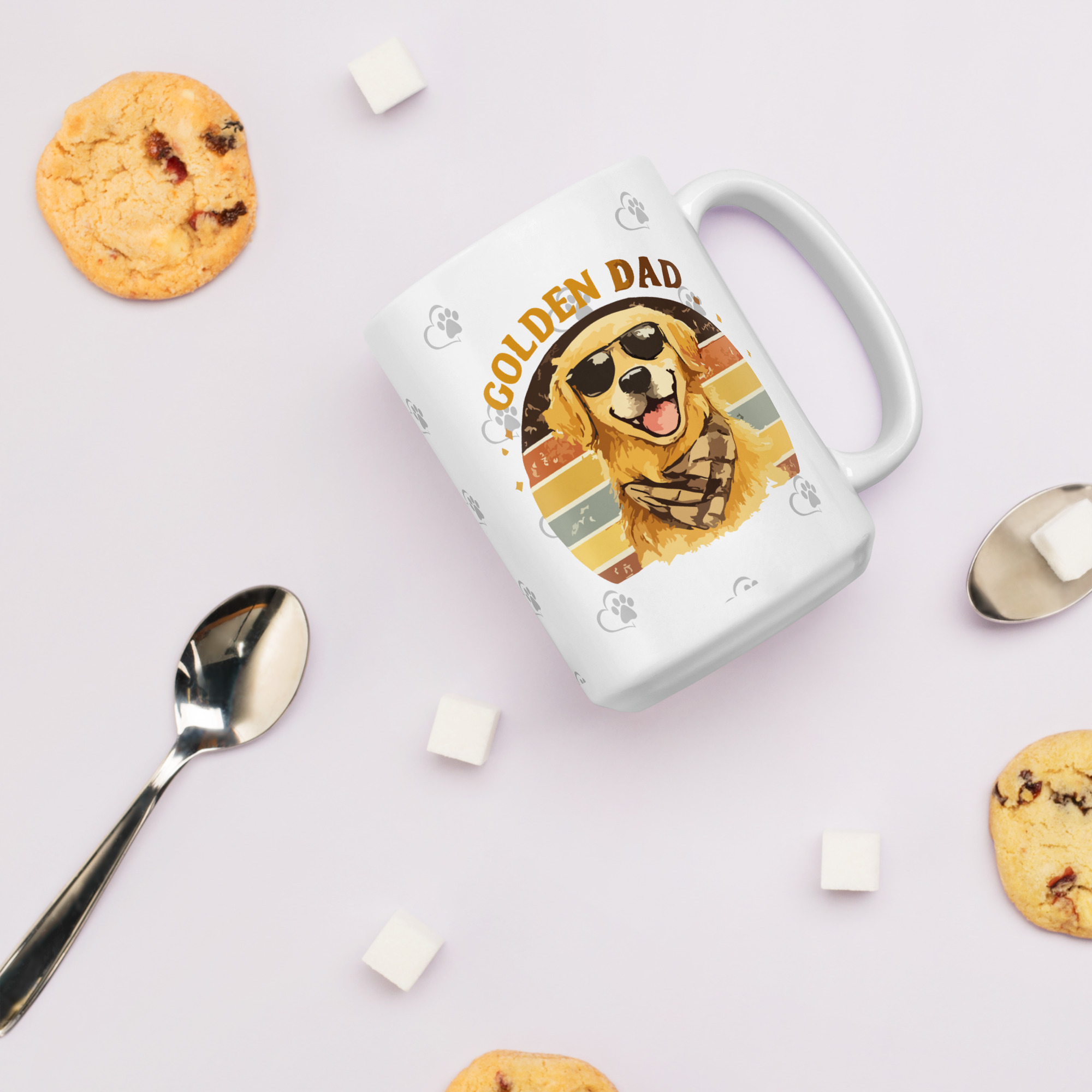 white-glossy-mug-white-15-oz-cookies-6a1b2b070921cjpg - Golden Retriever Gift Shop Optional tagline if the builder asks for one: Life is Better with Goldens White mug featuring a dog illustration and 'GOLDEN DAD' text, set on a pale pink background with cookies and sugar cubes nearby.