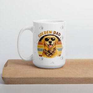 White ceramic mug on a wooden table featuring a colorful retro illustration of a golden retriever wearing sunglasses and the text 'Golden Dad' with paw prints around.
